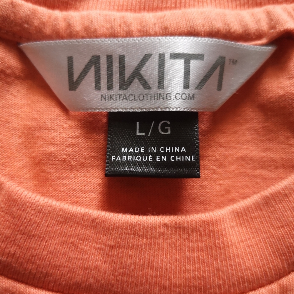 Nikita orange shirt.